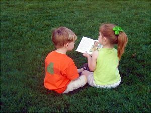 children-sharing-book