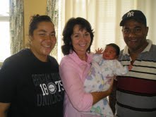 Proud parents with Sister Teni holding baby
