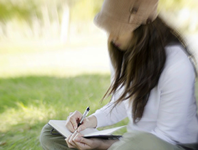 Young-woman-writing-on-travel-31566530-290x220