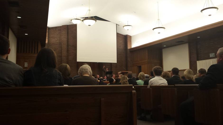 The congregation sings a hymn as we prepare for the realignment. (The screen is to project a map of the boundary changes)