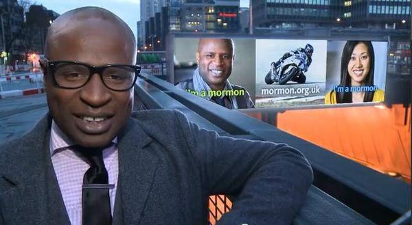 Alex Boye in London with his "I'm A Mormon" billboard behind him. Photo @deseretnews